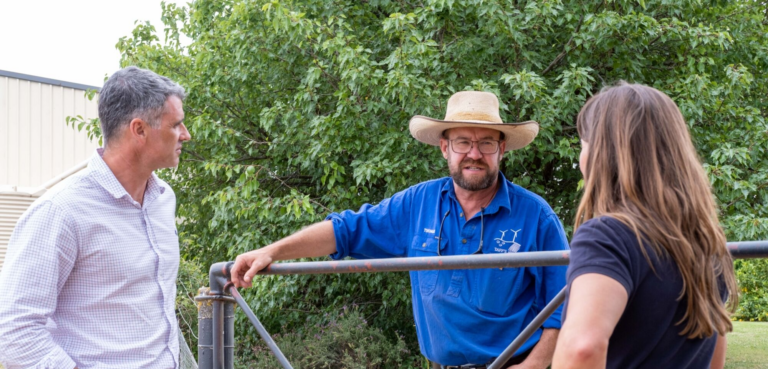3 people speaker over farm gate