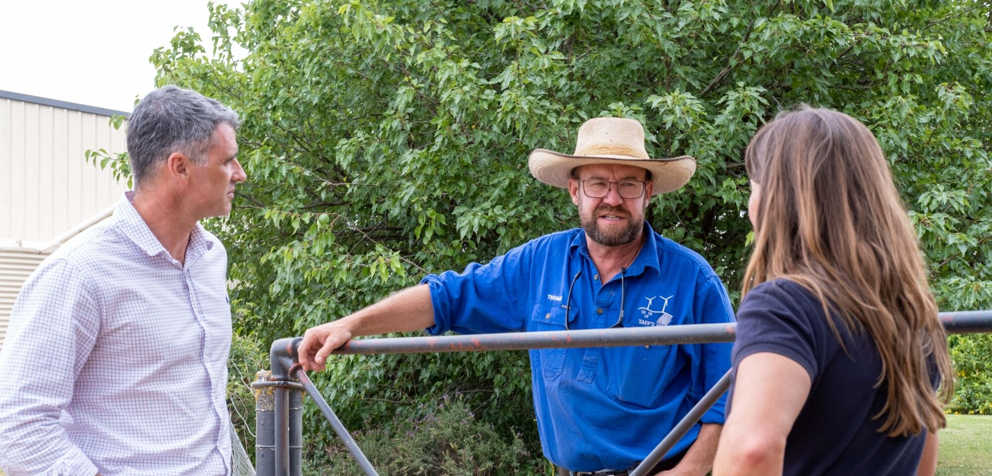 3 people speaker over farm gate